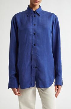 Maria McManus's mindful approach to fashion is reflected in the fresh, lightweight organic-cotton construction of this wardrobe-essential button-up. 30" length (size Medium) Front button closure Spread collar Long sleeves with button cuffs Curved hem 100% organic cotton Dry clean Made in the USA Designer Clothing Blue Silk Shirt With Button Closure, Blue Silk Blouse With Button Closure, Blue Relaxed Fit Shirt For Work, Blue Blouse With Spread Collar And Relaxed Fit, Blue Silk Button-up Shirt, Indigo Shirt For Spring Workwear, Spring Workwear Indigo Shirt, Blue Silk Button-up Top, Blue Button-up Shirt With Concealed Placket