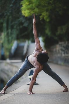 a man is doing yoga on the sidewalk