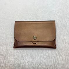 "| Handmade Leather snap wallet | Lightweight leather wallet small enough to fit into a pocket or small bag, but big enough for all of your essentials.  SIZE: 5.5\" x 3.75\" COLOR: Shiny Bronze < 1 interior compartmet < 4 card slots (fits 2 cards per slot) < Outer pocket on the back  < Hand-Stiched < Lightweight and Compact >> Other colors available in separate listings.  Shipping is included in the price. If you live in MONTREAL and would like to pick the item up, write me for a pick up code fo Everyday Brown Coin Purse With Card Slots, Envelope Coin Purse With Coin Pocket For Daily Use, Gold Bifold Coin Purse For Everyday Use, Gold Wallet With Coin Pocket For Everyday Use, Brown Envelope Card Holder For Everyday Use, Minimalist Envelope Wallet For Daily Use, Gold Wallet With Cell Phone Pocket For Everyday Use, Classic Gold Coin Purse For Everyday Use, Daily Use Envelope Coin Purse With Coin Pocket