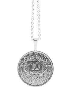 The MOROCCO Coin Necklace is handcrafted based on an authentic antique Moroccan coin with precious metals using the traditional lost-wax casting technique. The coin features beautifully rendered designs and islamic text reading Maroc and Empire Cherifien. The coin was minted in France in 1947 under the reign of Mohammed V during the time of French rule in Morocco. It features the numbers 1366, which is equivalent to the year of 1947 in the Islamic Calendar. It was in this year that Mohammed V, a Traditional Coin Medallion Necklace As A Gift, Traditional Coin Medallion Necklace For Gift, Traditional Medallion Necklace With Coin Pendant, Traditional Coin Medallion Necklace, Traditional Coin Necklace As A Gift, Traditional Coin Pendant Necklace For Gift, Traditional Round Coin Necklace, Traditional Engraved Round Medallion Necklace, Traditional Round Engraved Medallion Necklace