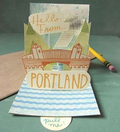 a handmade card with the word portland on it and a pencil next to it