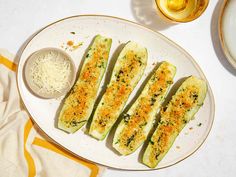 an eggplant dish with parmesan cheese and seasoning sits on a white plate