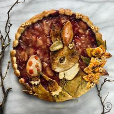 a pie decorated with an image of a rabbit and some flowers on top of it