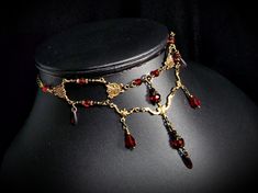 Blood Red Victorian Choker Crimson Gothic Drop Dark Red Edwardian Bridal Scarlet Steampunk Antique Gold Bronze  Titanic Temptations 23004 "Blood Red Victorian Choker" NReB23008 1 Victorian Style Necklace Handmade, Free Style Design Matching Earrings Available: https://www.etsy.com/listing/1540530458/blood-red-victorian-earrings-crimson   Blood Red Faceted Crystal Rondelles  Dark Red Crystal Teardrops Tiny Dark Red Czech Crystals  Bicones Crystals  Crystal Rhinestones  Art Nouveau Connectors Anti Gold Vampire Jewelry, Red And Gold Accessories, Dark Red Necklace, Red And Gold Necklace, Fantasy Necklace Art, Gold And Red Jewelry, Blood Necklace, Gold Red Earrings, Victorian Choker Necklace