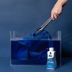 a person with a blue bag and a black handled cleaning tool in it's hand