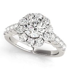 a white gold ring with diamonds on the sides and an oval center stone in the middle