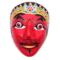 a red mask with colorful designs on it's face and eyes is shown in front of a white background