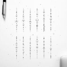 a white wall with some writing on it and a pen sitting next to the wall