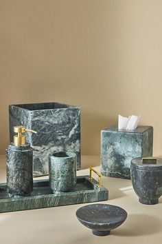 marble bathroom accessories including soap dispenser, toothbrush holder and soap dish