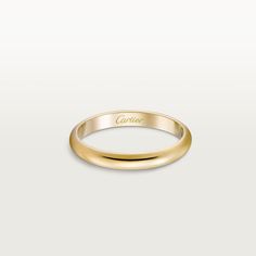 a yellow gold wedding ring with the word cartier engraved on it's side