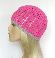 a mannequin head wearing a pink crochet hat