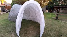 a white tent sitting on top of a lush green field