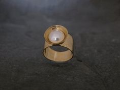 Classic Brushed Matte Gold Ring, Unique Engagement Ring, Pearl Ring, Engagement JewelryMade of 22k gold plated brass and natural gemstone round white pearl .A round freshwater pearl set in a beautiful 22k matte gold plated  Bezel ring.This ring can be ordered with a white pearl ,black or a pink pearl .Ring width: 1cm (0.39" ) Circle diameter: 1.5 cm (0.59" )This ring comes in a beautiful gift box. each one is a bit different.Payment and Shipping Info:I accept PayPal and credit card!I ship worldw Handmade Gold Pearl Ring For Anniversary, Handmade Gold Pearl Ring For Formal Occasions, Handmade Gold Pearl Ring, Handmade Yellow Gold Pearl Ring For Anniversary, Handmade Yellow Gold Pearl Ring, Gold Pearl Engagement Ring, Pearl Ring Engagement, Engagement Ring Pearl, Pink Pearl Ring