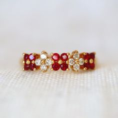 two red and white diamond rings sitting on top of each other