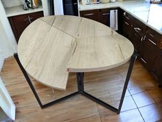 a wooden table with metal legs in a kitchen