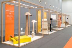 a room filled with lots of different types of lamps and furniture on display in glass cases