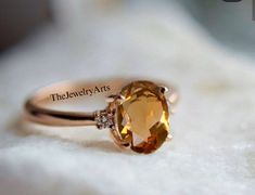 "Most Welcome to \"TheJewelryArts\" Products Description Center Stone: Genuine Golden Topaz Center Stone Size: 6x8mm Stone Shape: Oval Cut   Side Stone:- Cubic Zircon Stone Clarity: VVS Material: 92.5 Sterling Silver, also available in 24k Rose Gold Vermeil/Gold Vermeil/Black Vermeil Stamp: 92.5 ➽OCCASION: Surprise your loved one with this beautiful engagement/wedding jewelry by TheJewelryArts . A classic piece of jewelry for all men/women in your life, this is a perfect gift for any occasion such as birthdays, anniversaries, wedding, engagements, Valentine's Day or Christmas day mother's day. ✔Comfort Fit ✔Nickel Free ✔Free Engraving ✔ Free Shipping ✔  Ready to Ship in 3 Business Day Customization is always welcome and please feel free to contact with me if you have any design ideas! If y Oval Yellow Topaz Promise Ring, Yellow Oval Topaz Promise Ring, Fine Jewelry Yellow Oval Topaz Ring, Yellow Oval Topaz Rings, Yellow Oval Topaz Ring With Center Stone, Oval Yellow Topaz Ring With Accent Stones, Yellow Oval Topaz Ring With Accent Stones, Topaz Ring Yellow, Yellow Topaz Ring