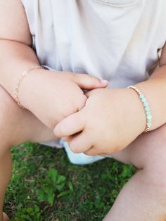 "Jade Baby Bracelet/ Green Beaded Toddler Bracelet/ Personalized Baby Bracelet/ Baby Girl Bracelet/ Toddler Bracelet with Initial Beautiful bracelet is made from 4mm Natural Burma Jade Beads. On each side of the Jade beads, 14 K Gold Filled beads adorn this elegant bracelet. Listing is for one jade bracelet. Option to add disc charm is additional The disc charm is 14 K gold filled also. Initial of choosing is stamped on disc. Bracelet comes with adjustable slide clasp. The clasp simply slides up Adjustable Stackable Bracelets For Birthday, Adjustable Pink Bracelet For Playtime, Pink Adjustable Bracelet For Playtime, Adjustable Pink Bracelets For Playtime, Adjustable Dainty Beaded Bracelets For Birthday, Adjustable Hypoallergenic Charm Bracelet For Birthdays, Adjustable Hypoallergenic Charm Bracelet For Birthday, Dainty Adjustable Beaded Bracelets For Birthday, Cute Adjustable Hypoallergenic Name Bracelet