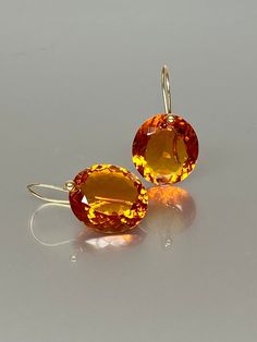 Gorgeous Madeira Citrine drops earrings. The oval  Madeira Citrine drops are eye clean, flawless, and have a beautiful rich golden whiskey color. The drops are attached to 24k gold vermeil /14K SOLID GOLD ear wires. The earrings are elegant, have a lux look, and make a statement.  A truly gorgeous pair of earrings. When 14K SOLID GOLD ear wires are being used, the ear wire ends are hand-stamped as proof of being 14K solid gold. In addition, extra work was done at the end of the ear wires to prev Orange Gemstone Drop Earrings, Luxury Citrine Earrings, Orange Gemstone Drop Jewelry, Orange Drop Gemstone Jewelry, Orange Teardrop Gemstone Earrings, Luxury Orange Drop Earrings, Orange Drop Earrings For Formal Occasions, Fine Jewelry Briolette Faceted Earrings, Orange Citrine Gemstone Earrings