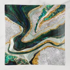 an abstract painting with green, gold and white colors on it's surface is featured in this image