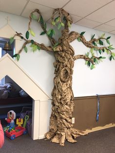 a child's room with a tree made out of cardboard