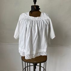 Hello and welcome to the Textile Trunk! Please follow us on Instagram , our user name is textiletrunk A fabulous rare find! Lace trimmed, GORGEOUS! his textile is a choir blouse dating from c 1900 or late 1800's. Made of crispy white cotton , This shirt was a Choir blouse and has lovely mends! ~ it was used and loved. There are some small stains on the back of one of the sleeves near the mends that would probably come out with some spot bleach work! I LOVE this blouse!! ( Eshirt 11094) MEASUREME Victorian Lace Trim Top For Daywear, Victorian White Cotton Top, Victorian Style White Cotton Top, Cotton Peasant Blouse For Daywear, Cotton Tops With Lace Trim For Daywear, Victorian Cotton Tops With Lace Trim, Victorian Cotton Top With Lace Trim, Vintage Cotton Peasant Top With Short Sleeves, Victorian Cotton Tops For Summer