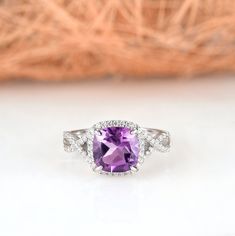 Gorgeous cushion cut amethyst ring is made of 925 solid sterling silver, making a simple but elegant statement piece. This ring is perfect to wear as engagement ring, promise ring, birthstone ring, or statement piece. ►Average band width: 2.3 mm ►True to size. ►Your sterling silver ring will not turn green itself and will not cause your skin to turn green. Center Stone: Amethyst Shape: Cushion Size: 8.0 x 8.0 mm Carat Weight: 2.5 ct. (approx.) Gemstone creation: Natural Hardness: 7 (Mohs scale) Elegant Amethyst Ring With Diamond Accents For Anniversary, Elegant Amethyst Ring With Halo Design For Anniversary, Fine Jewelry Amethyst Ring With Halo Design For Anniversary, Classic Purple Diamond Ring With Halo Setting, Wedding Amethyst Diamond Ring With Diamond Accents, Elegant Amethyst Halo Ring For Anniversary, Wedding Amethyst Diamond Ring With Accents, Purple Rings With Diamond Accents For Wedding, Classic Purple Diamond Wedding Ring