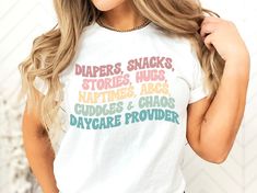 a woman wearing a t - shirt that says diapers, snacks, stories, hugs, natives, abcs, cuddles and chaos