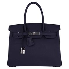 Mightychic offers a rich Hermes Birkin 30 bag featured in Bleu Indigo. This rich deeply saturated dark blue iBirkin bag s a timeless classic. Crisp with palladium hardware. Classic and timeless this beautiful Hermes bag takes you from to evening in one step. Comes with the lock and keys in the clochette, signature Hermes box with ribbon, sleepers and raincoat. NEW or NEVER WORN. final sale BAG MEASURES: LENGTH 30 cm / 12" TALL 21 cm / 8.5" DEEP 15 cm / 6" HANDLES: TALL 4" CONDITION: NEW or NEVER Blue Birkin, Birkin Handbags, Box With Ribbon, Birkin 30, Cargo Pants Outfit, Blue Accessories, Hermes Birkin 30, Hermes Box, Luxury Lifestyle Dreams