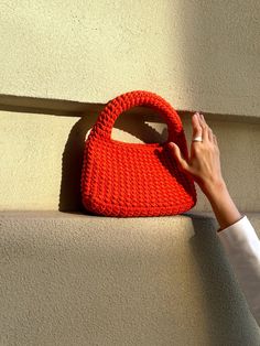 Crochet handbag crochet mini bag, stylish bag minimalistic bag, handcrafted wrist bag Get in touch with the art of handmade accessories with our exquisite crocheted hand bag - a gorgeous knitted  craft that will catch the eye of those around you. The perfect summer bag with a minimalist design will be a favorite accessory for a woman. Key Features: ● Minimalistic design: This crochet bag has a simple minimalist design, but the crocheted texture is the highlight of this accessory. ● Handcrafted Elegance: Skillfully knitted with precision, our Crochet Hand Bag exudes the charm of a handmade masterpiece, making it an ideal DIY gift for girlfriend or a delightful addition to your collection. ● Compact and Stylish: The Crafted Mini Wrist bag  offer the perfect blend of convenience and style, en Chic Everyday Knitted Bag, Chic Handwoven Crochet Bag With Top Handle, Trendy Handheld Crochet Bag With Braided Handles, Trendy Crochet Handheld Bag With Braided Handles, Trendy Handheld Handwoven Shoulder Bag, Trendy Handheld Crochet Bag, Crochet Handheld Bag With Detachable Handle For Daily Use, Trendy Hand Knitted Shoulder Bag, Trendy Handheld Crochet Bag For Gift