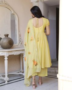 This is a beautiful 3 piece anarkali suit set.The set includes anarkali style kurta has round neck, short sleeves & calf length.It also comes with solid pants with semi elasticated waistband and a hand painted dupatta with and tassels and lace detailing. Suit Fabric-Mul Cotton Dupatta Fabric-Chiffon Length-Calf Length Color - Yellow Neck-Round Neck Sleeves-3/4th sleeves Washing Care-Dry Clean or Quick Deep Wash DISCLAIMER - The color of the product may be differ due to screen settings of device. Painted Dupatta, Brush Paint, Cotton Dupatta, Anarkali Suit, Suit Fabric, Suit Set, Anarkali, 3 Piece, Tassels