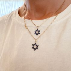 This meaningful pendant is the universal symbol of the Jewish star, known as the Star of David.  The charm is composed of 14K solid gold and beautifully finished with AAA quality natural real round brilliant cut blue sapphires which are accented with black rhodium detailing.   ♦ Star of David Dimensions: approximately 12.5mm (W) x 12.5mm (L) not including the bail x 1.75mm thickness ♦ Weight: approximately 1.25 grams of 14K solid gold ♦ Metal Finish: High Shine Polish ♦ This design is available Celestial Star Of David Necklace With Star Charm, Yellow Gold Star Of David Charms Jewelry, Symbolic Gold Jewelry With Star Charm, Spiritual 14k Gold Star Of David Jewelry, Engraved Yellow Gold Star Of David Jewelry, Gold Star Of David Jewelry For Hanukkah, Yellow Gold Charm Necklace With Star Of David Charm, 14k Gold Star Of David Necklace Engraved, Star Of David Yellow Gold Plated Jewelry