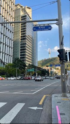 an intersection with cars and buildings in the background