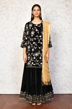 Black kurta with contrast floral embroidery. Paired with a lehenga, highlighted with floral embroidered hem. Comes along with a dupatta.
Components: 3
Pattern: Embroidery
Type Of Work: Floral
Neckline: Round Neck
Sleeve Type: Three Quarter Sleeves
Fabric: Kurta and Lehenga: Velvet, Dupatta: Chanderi, Lining: Shantoon
Color: Black
Other Details: 
Length:
Kurta: 36 inches
Lehenga: 40 inches
Occasion: Mehendi and Haldi - Aza Fashions Black Palazzo Set With Zari Work For Navratri, Traditional Black Palazzo Set For Festive Occasions, Black Sharara With Resham Embroidery For Transitional Season, Transitional Black Sharara With Resham Embroidery, Black Sharara For Festive Occasions, Black Chanderi Sharara With Resham Embroidery, Black Chanderi Palazzo Set With Dupatta, Black Chanderi Palazzo Set For Festive Occasions, Festive Black Chanderi Sharara