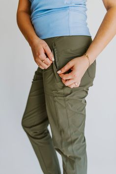 Finally pants that are functional and fashionable. No more choosing between cargo pants or yoga pants for your adventures, Go anywhere in the Vera Jogger; rappelling, rock climbing, canyoneering, or hiking. You name it, these pants can handle it. They can handle the elements of the outdoors but are so comfortable you will find yourself wearing them around the house or running errands in them. They are comfortable, sleek, and incredibly lightweight. The flattering pocket angle with zippers to sec Lightweight Joggers, Women's Joggers, Cute Hiking Outfit, Hiking Clothing, Hiking Pants Women, Womens Outdoor Clothing, Women's Athletic Wear, Green Joggers, Adventure Outfit