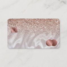 a pink and gold glitter credit card with two circles on the front, in white marble