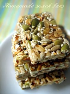 three granola bars stacked on top of each other with nuts and seeds in the middle