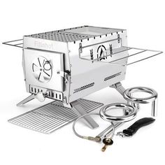 an image of a portable grill set up on the ground with accessories for cooking food