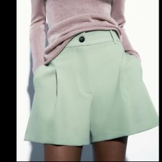 High-Waisted Shorts With Belt Loops Waistband. Side Hidden In-Seam Pockets And Back Welt Pockets. Front Pleat Detail. Front Zip And Button Closure. Chic Bottoms With Built-in Shorts For Work, Trendy Wide Leg Shorts In Solid Color, Trendy Wide Leg Shorts, Trendy Spring Pants With Built-in Shorts, Trendy Workwear Pants With Built-in Shorts, Green Wide Leg Shorts With Pockets, Trendy Bermuda Shorts For Spring Workwear, Trendy Spring Bermuda Shorts For Workwear, Spring Workwear Bottoms With Short Inseam