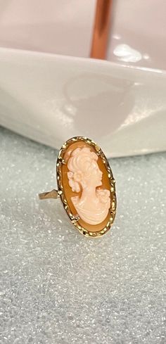 Italy 14K/585 Gold Shell Cameo Ring. Made in Italy circa 1920's. Traditional Italian cameo ring. Seashell pink/salmon color- color appears much softer and richer in person. The portrait of a Nole lady, is a classic cameo figure, floral accents in her hair and dress. Hair swept up ever so lady like and gently. It's exquisite. US Size 8  4g 10.84mm Right facing Lady Hallmark Verona Stamped 585 aka 14K Made of 14 kt Italy gold  Ring is in excellent condition Hand crafted and designed in Verona, Ita Luxury Elegant Cameo Ring, Antique Cameo Jewelry, Seashell Ring, Seashell Pink, Art Nouveau Ring, Cameo Earrings, Coral Pendant, Cameo Jewelry, Cameo Ring