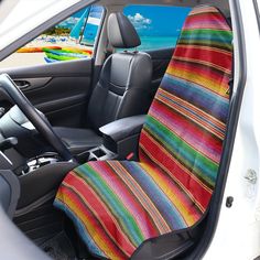 the interior of a car with a colorful seat cover