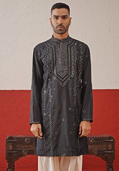 Elevate your style with Black Embroidered mirror Kurta. Made from luxurious georgette, the classic black kurta ensemble showcases intricate mirror work and stunning all-over motifs. The elegant yoke design adds a touch of sophistication. Fashioned with the embroidered dupatta and white pants. Perfect for Cocktail parties. Composition : Kurta, Patiyala & Dupatta : Viscose Georgette Care: Dry Clean Only and Vacuum Storage This product can be customized for sleeves, length and colour Delivery : 4-6 weeks as the product is hand crafted. Check Size Guide or choose MySize for free customisation (All Sizes above XL can be made at 15% additional cost) For more information and sizes please contact fabiliciousfashion@gmail.com or visit our Copenhagen studio. About the Designer : Welcome to Kalpraag, Mirror Work Kurta, Intricate Mirror, Yoke Design, Black Kurta, Vacuum Storage, Indian Wedding Wear, Embroidered Dupatta, Cocktail Parties, Mirror Work