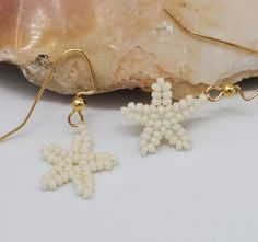 Hand beaded earrings for summer months. Starfish shaped. Each bead is individually strung together. Ear wire is hand tied three times for security. Optional colors are available. Blue, cream, pink, purple. Message me. I am happy to  make alternative colors made to order. White Starfish Charm Earrings For Gift, White Starfish Charm Earrings As Gift, White Starfish Charm Earrings, Star-shaped Beaded Earrings With Ear Wire For Gifts, Star-shaped Beaded Earrings With Ear Wire As Gift, White Star-shaped Earrings With Starfish Charm, White Starfish Charm Star Earrings, White Star Earrings For Beach, Earrings For Summer