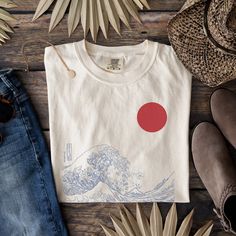 Japanese Wave T-Shirt, The Great Wave Shirt, Japanese Art Shirt, Aesthetic  Shirt, Japanese Tee, Wave Shirt, Art Shirt, Oversized Shirt 🌸Item Details:🌸 -Made to order -Unisex Tee  -Available in many sizes and colors!  -Super Versatile -For an oversized look I recommend sizing up -Japanese Wave Art Tee ⭐️Materials: ⭐️ COMFORT COLORS  ⭐️100% ring-spun cotton ⭐️Medium fabric (6.1 oz/yd² (206.8 g/m ⭐️Relaxed fit ⭐️Sewn-in twill label **Please review size chart in photos prior to purchasing ✨PRODUCTION TIME✨ Production takes about 1-3 days. Within this timeframe you will receive an email letting you know your item has shipped with a tracking number for your item. ✨SHIPPING TIME✨ Shipping takes about 2-5 days. ✨CARE INSTRUCTIONS ✨ COMFORT COLORS -Wash separately to avoid color bleeding or wash Artsy White Crew Neck T-shirt, Artistic White Shirt With Screen Print, Artistic White Relaxed Fit Shirt, Artsy Cotton Shirt With Graphic Design, Artistic Crew Neck Shirt With Custom Print, Artistic Relaxed Fit Shirt With Screen Print, Artistic Graphic Crew Neck Shirt, Artistic Cotton Crew Neck Shirt, Artsy Crew Neck Shirt With Relaxed Fit