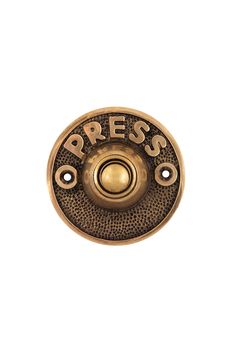 an antique brass press button with the wordpress printed on it's center hole