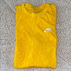 Yellow Nike T-Shirt, Never Worn Nike Crew Neck Top With Text Print, Nike Basic Tops With Letter Print, Nike Tops With Logo Print For Spring, Nike Yellow T-shirt With Graphic Print, Nike Crew Neck Top With Graphic Print, Nike Short Sleeve Top With Text Print, Basic Nike Tops With Letter Print, Nike Yellow Graphic Print Tops, Nike Graphic Tee For Summer