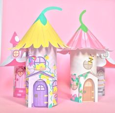 two paper houses are shown on the screen, one has a pink background and the other is