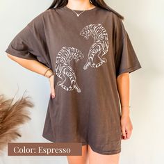 Roar into style with our Comfort Colors Vintage Tiger Shirt! This cute and easy tiger shirt is the perfect addition to your wardrobe. With its boho-inspired design and aesthetic appeal, it's a great gift for her or anyone who loves tigers. Embrace your wild side and stand out with this trendy tiger shirt that will surely turn heads. Whether you're heading out for a casual day or making a bold fashion statement, this vintage tiger shirt is a must-have in your collection! All clothing and accessor Tiger Graphic Tee, Tiger Print Short Sleeve T-shirt For Summer, Short Sleeve Tiger Print T-shirt For Summer, Black Tiger Print Crew Neck Top, Black Crew Neck Top With Tiger Print, Casual Tiger Print Tops For Spring, Tiger Print Crew Neck Graphic Tee, Casual Cotton Tops With Tiger Print, Casual Cotton Tiger Print Tops