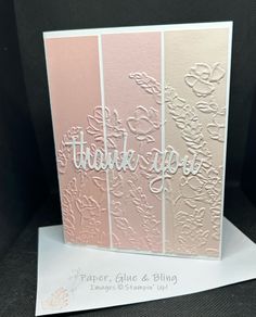 a thank card with the words thank you in white lettering on pink and beige cards