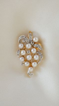 * Pendant Material: Pearl, Diamond, 14k Yellow Gold  * Pendant Dimensions: 1.5x0.90 Inch * Stone Weight & sizes: Pearl - 4.4-4.6MM, Diamond - 0.25ct  * Overall weight: 6.5g Exquisite White Wedding Brooches, Exquisite Diamond Accented Brooches For Wedding, Classic Diamond White Brooch For Anniversary, Classic Diamond White Brooches For Anniversary, Exquisite Wedding Brooches With Diamond Accents, Elegant Diamond White Brooches For Wedding, Elegant Diamond White Wedding Brooches, White Gold Brilliant Cut Brooches For Wedding, White Brilliant Cut Brooches For Wedding